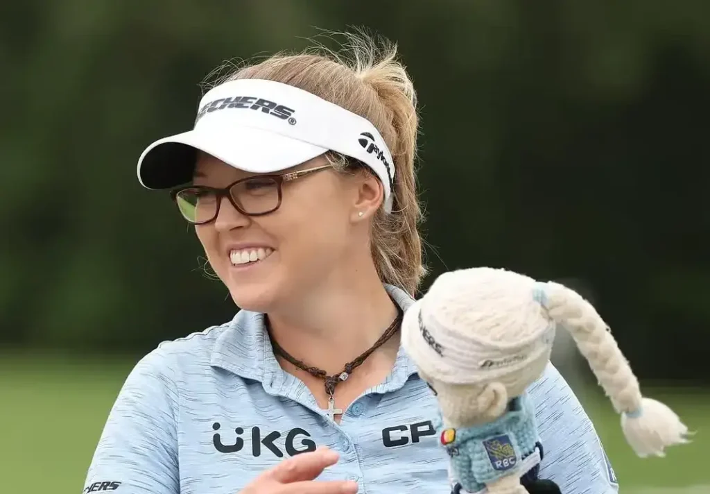Brooke Henderson holding trophy after LPGA Tour victory, Canadian professional golfer major champion